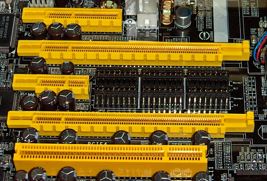 Close-up photograph of a motherboard showing several PCI Express expansion slots of noticeably different physical lengths